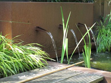 stads-tuinontwerp stads oase in nijmegen van het buitenland met een corten stalen muur met 3 waterspuwers boven een vijver